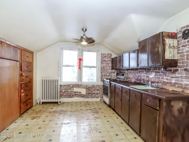 a kitchen with stainless steel appliances a sink stove and cabinets