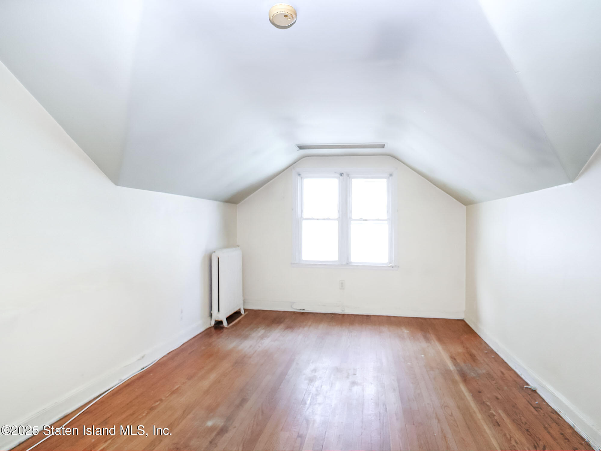 151 Clinton B Fiske Avenue Staten Island, NY 10314 - Photo 24 of 33 an empty room with wooden floor and windows