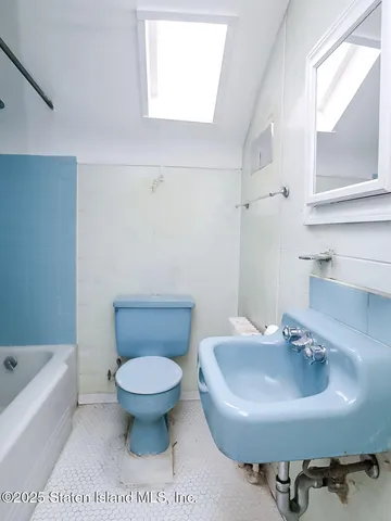 a bathroom with a sink toilet and bathtub