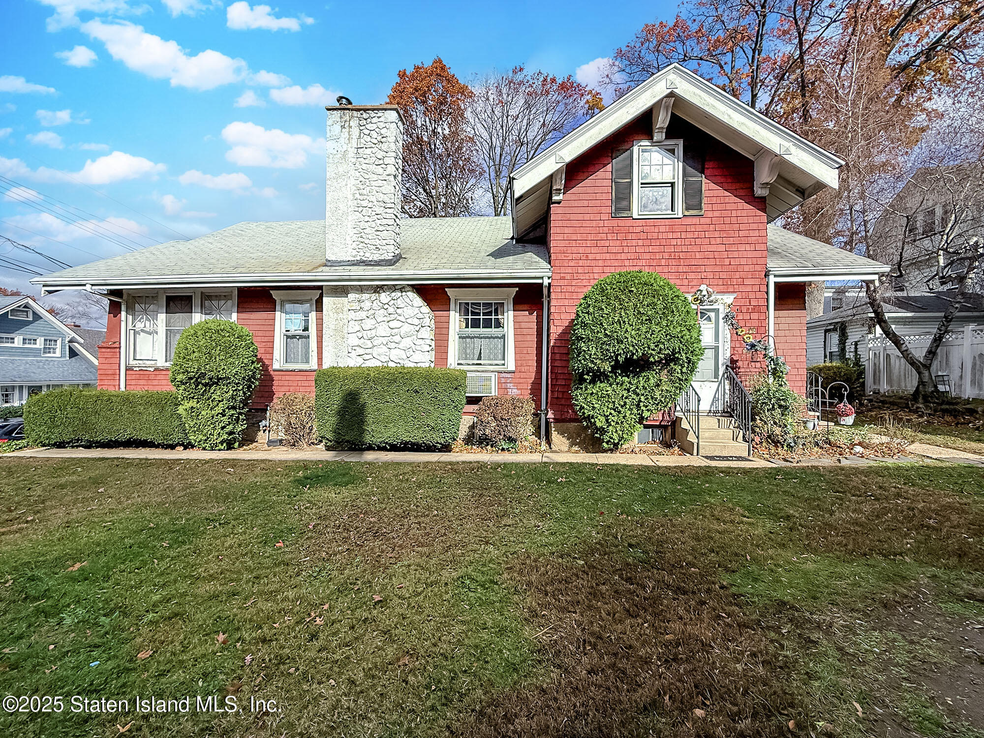 151 Clinton B Fiske Avenue Staten Island, NY 10314 - Photo 30 of 33 a front view of a house with a yard and garage