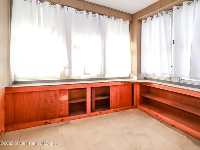 a view of a kitchen with large windows