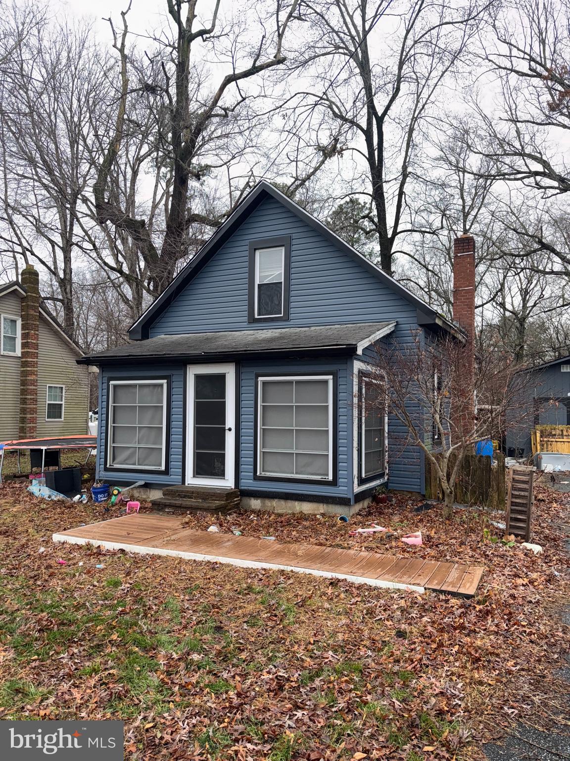 491 Broad Street Houston, DE 19954 - Photo 2 of 22 a view of a house with a yard covered in snow