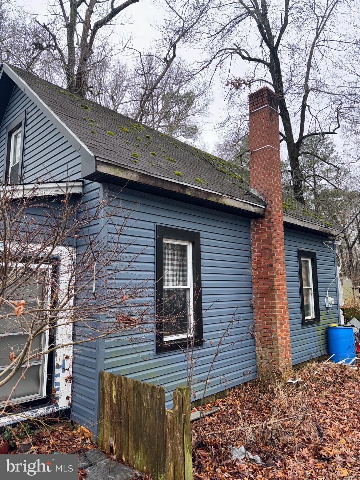 491 Broad Street Houston, DE 19954 - Photo 3 of 22 a brick house with a large tree