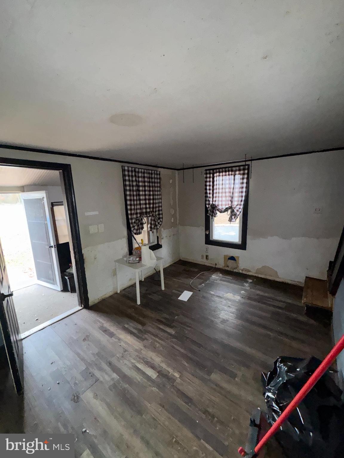 491 Broad Street Houston, DE 19954 - Photo 4 of 22 a view of an empty room with wooden floor and windows