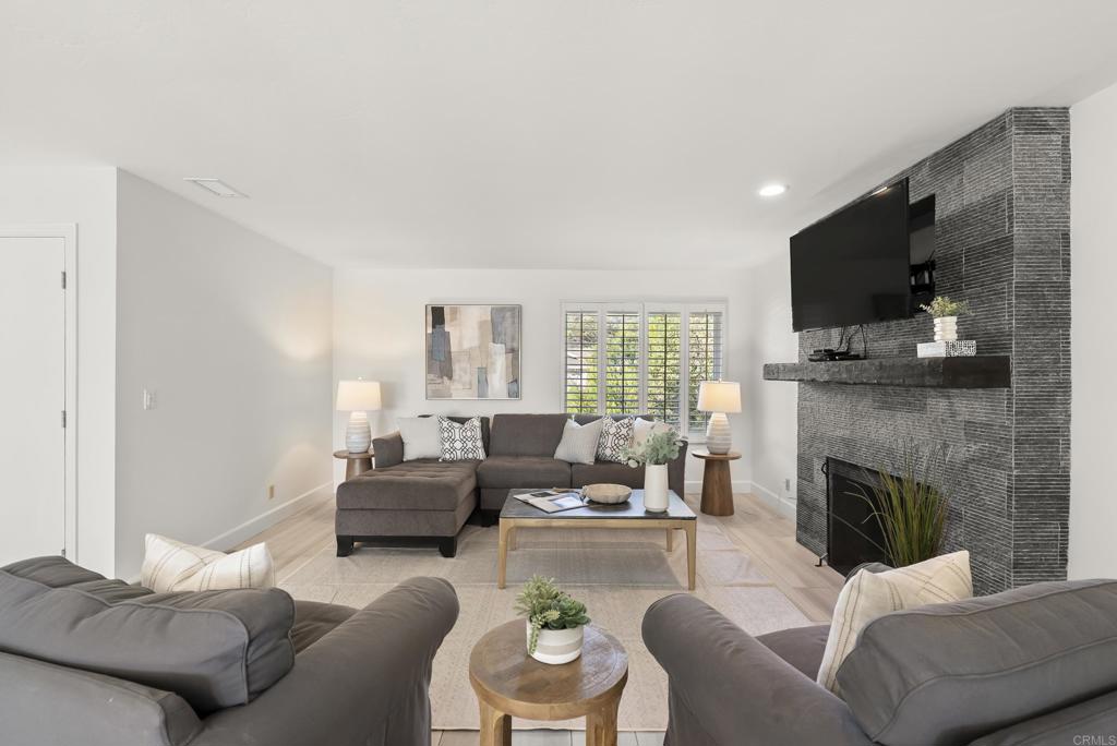 147 Witham Road Encinitas, CA 92024 - Photo 11 of 47 a living room with furniture a flat screen tv and a fireplace