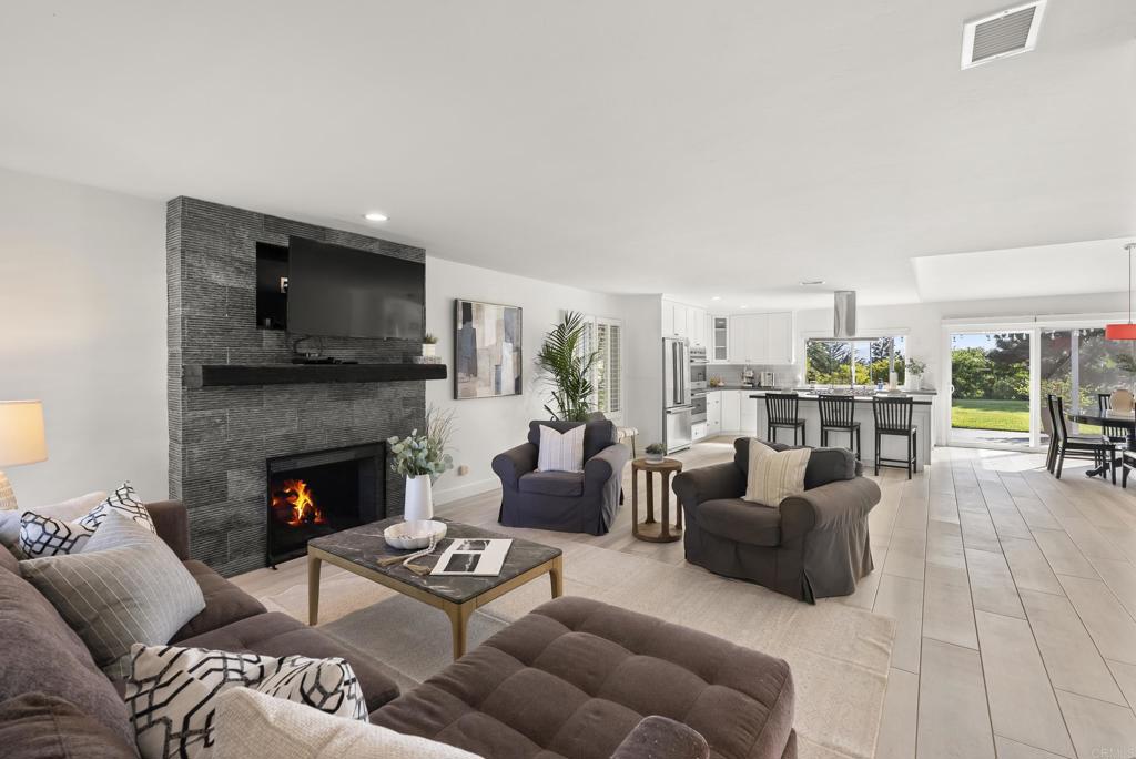 147 Witham Road Encinitas, CA 92024 - Photo 12 of 47 a living room with furniture flat screen tv and a fireplace