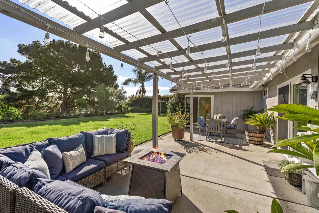 147 Witham Road Encinitas, CA 92024 - Photo 34 of 47 a view of a patio with couches table and chairs and a yard