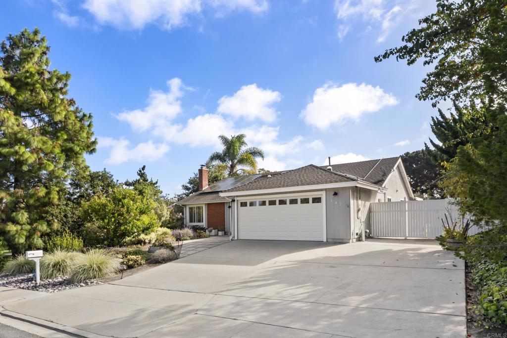 147 Witham Road Encinitas, CA 92024 - Photo 4 of 47 a front view of a house with a garden and trees