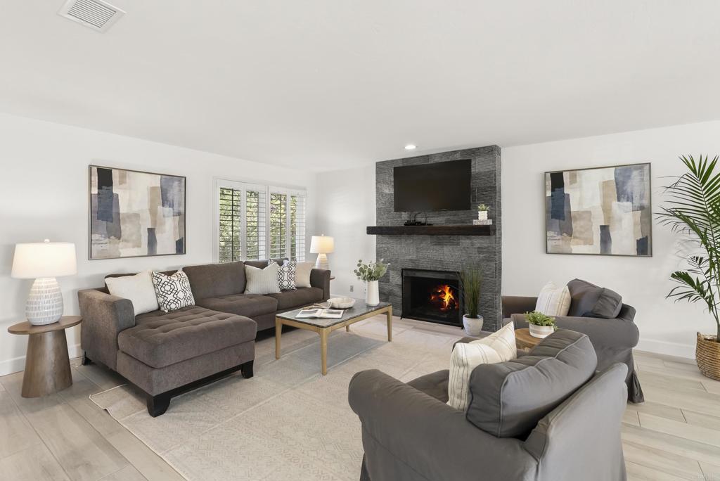 147 Witham Road Encinitas, CA 92024 - Photo 10 of 47 a living room with furniture a flat screen tv and a fireplace