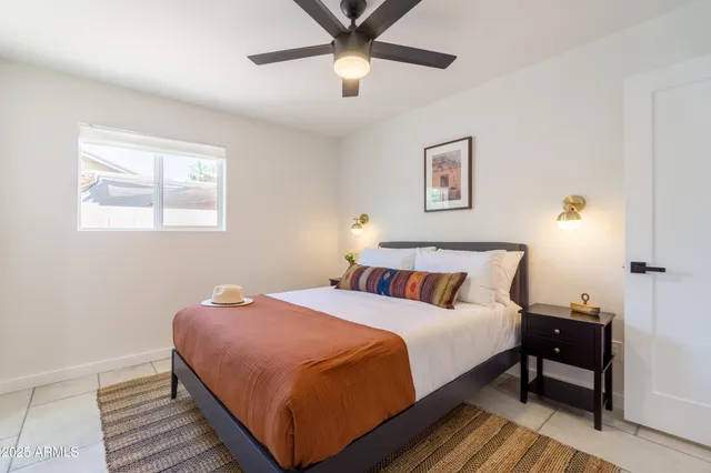 a bedroom with a bed and a potted plant