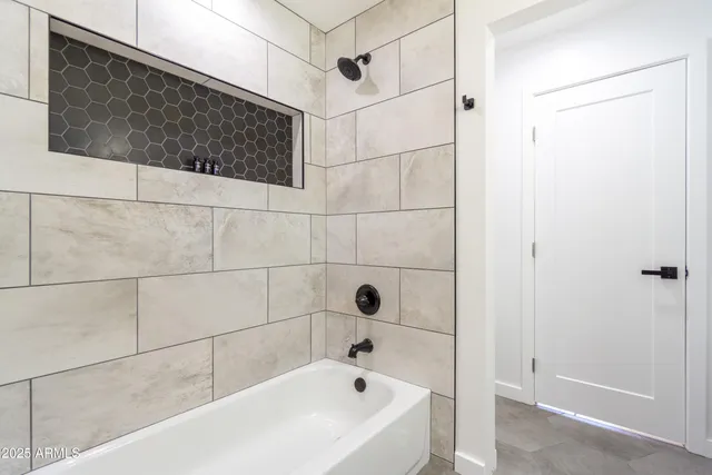 a spacious bedroom with a bed and painting on the wall