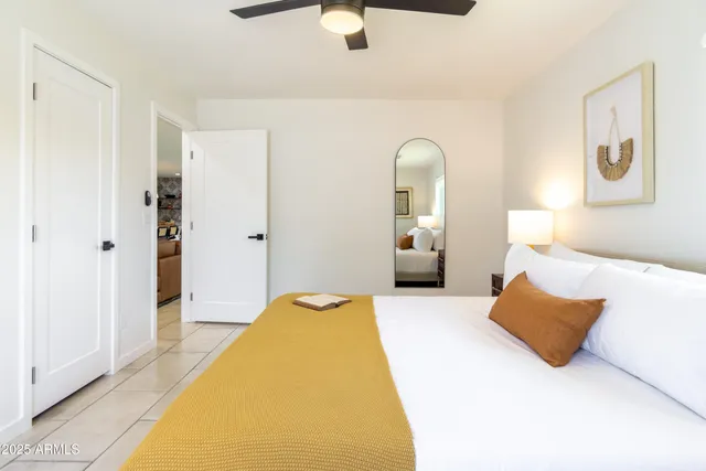 a bedroom with a bed and a table