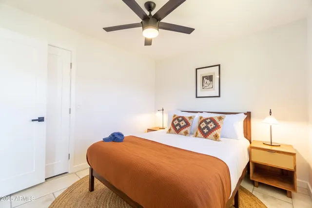a bedroom with furniture and a flat screen tv