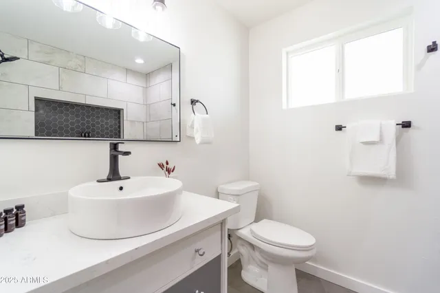 a view of a kitchen with a sink and wooden floor