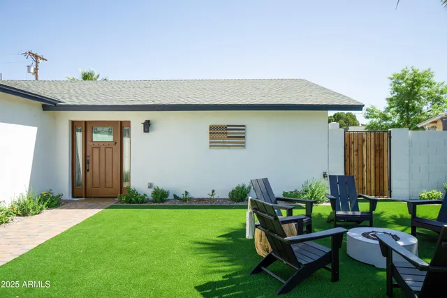 a living room with lots of furniture and view of kitchen