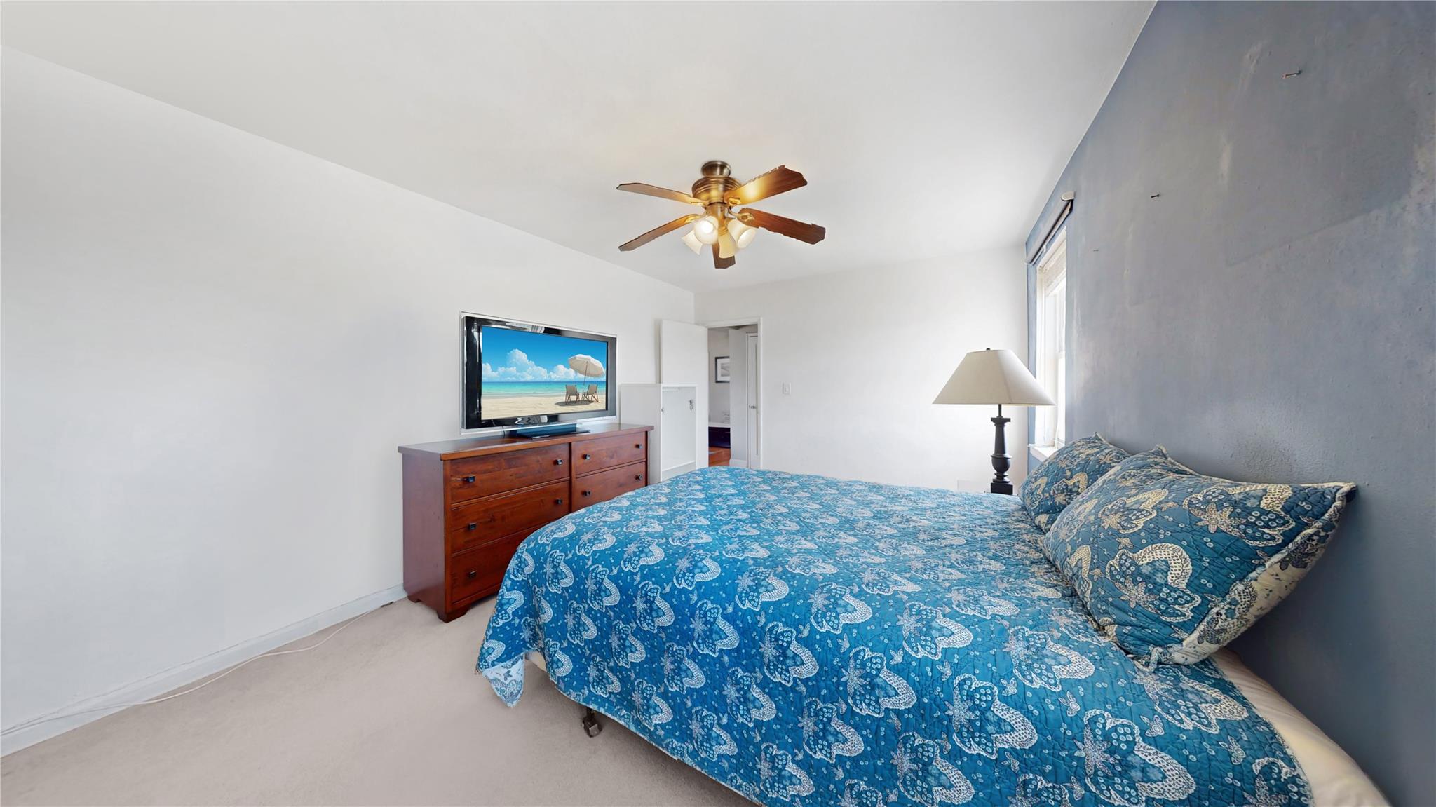 138-25 68th Drive, Unit 3D Queens, NY 11367 - Photo 11 of 12 Bedroom with a ceiling fan, baseboards, and light colored carpet