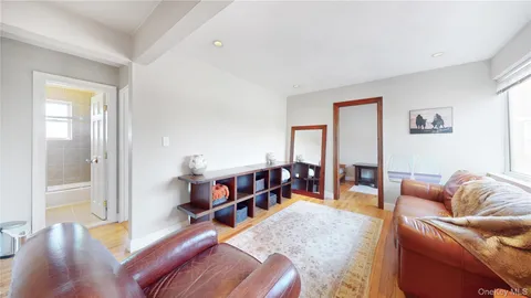 a living room with furniture and a dining table