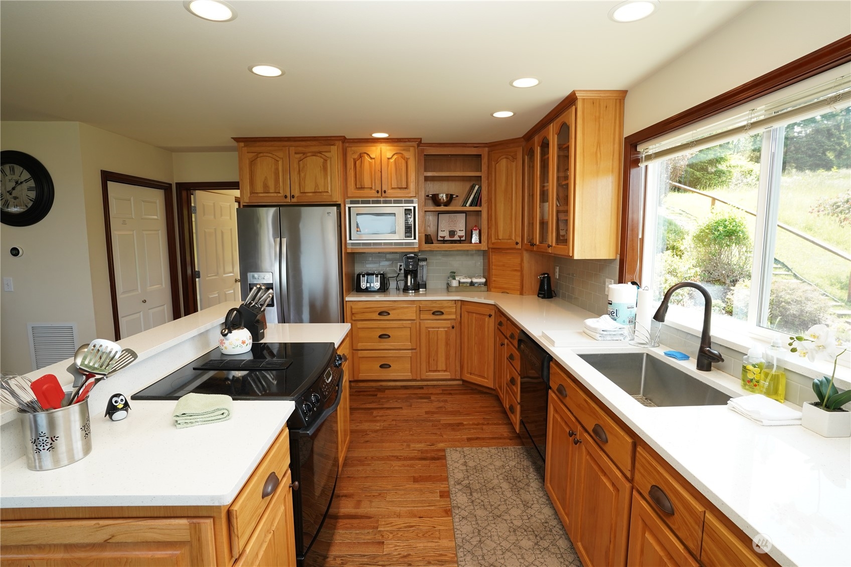 522 Fox Hollow Road Sequim, WA 98382 - Photo 9 of 40 a kitchen with kitchen island granite countertop a sink appliances cabinets and a counter top space