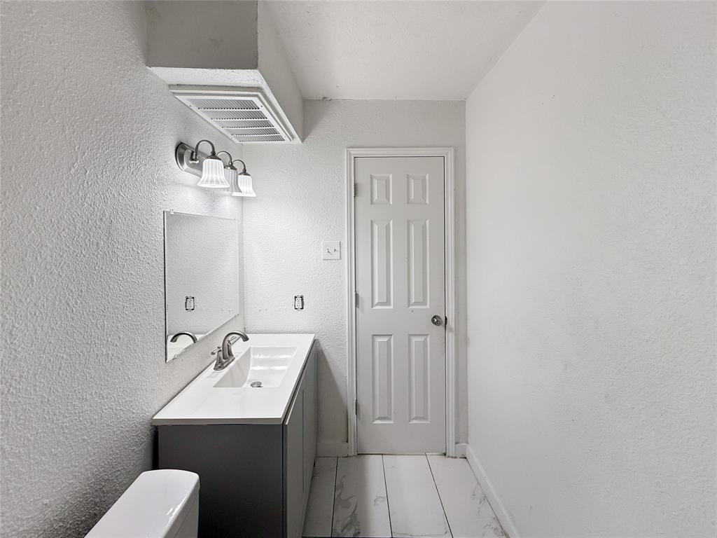 3549 Rio Grande Circle Dallas, TX 75233 - Photo 12 of 23 a bathroom with a sink and mirror