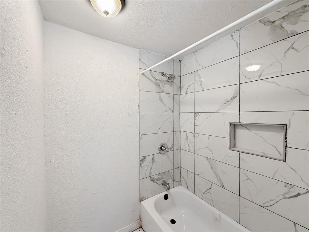 3549 Rio Grande Circle Dallas, TX 75233 - Photo 14 of 23 a bathroom with a white bathtub and shower