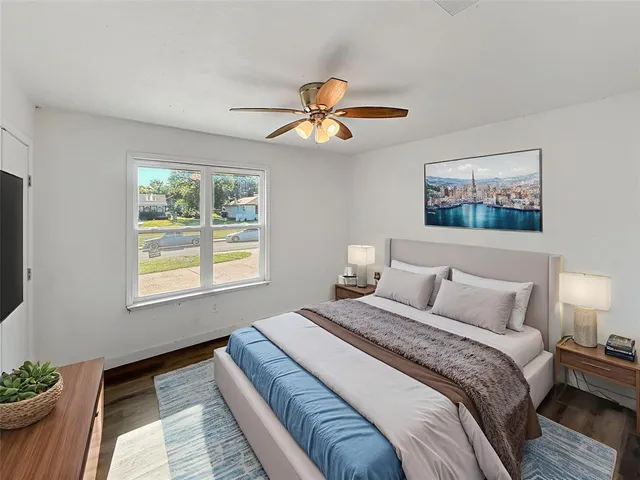 a bedroom with bed and a chandelier