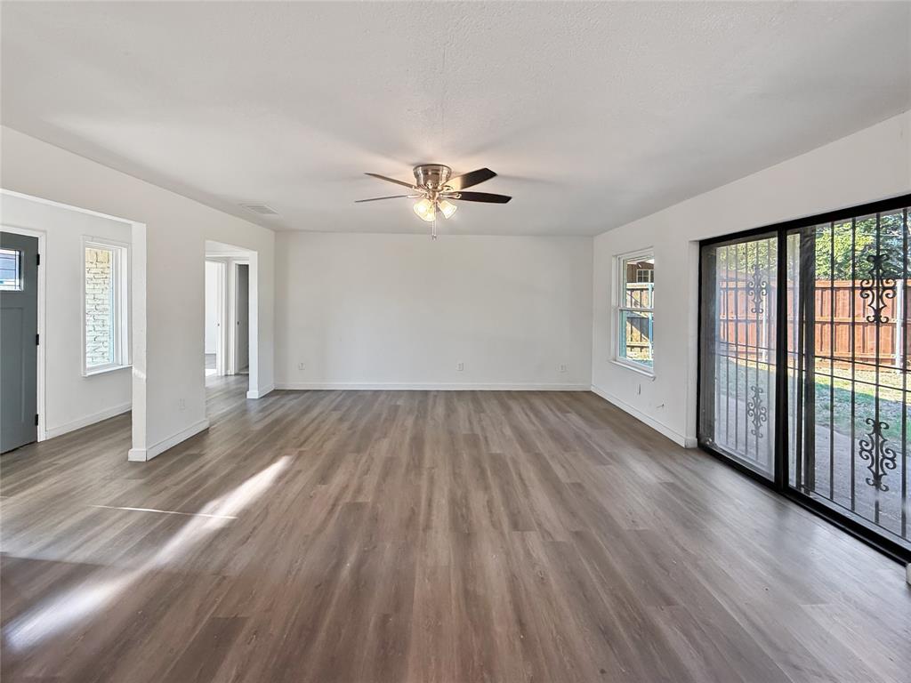 3549 Rio Grande Circle Dallas, TX 75233 - Photo 8 of 23 an empty room with wooden floor and a ceiling fan