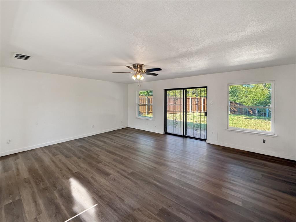 3549 Rio Grande Circle Dallas, TX 75233 - Photo 10 of 23 an empty room with wooden floor and windows