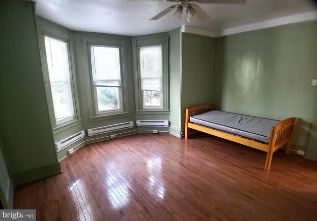 a view of a room with wooden floor and windows