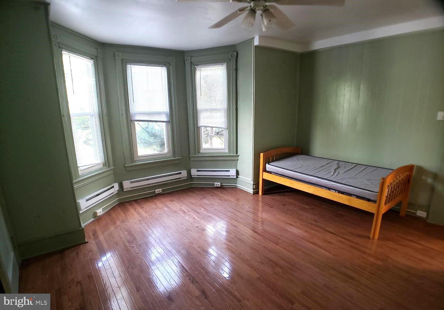 408 South 45th Street, Unit 2F Philadelphia, PA 19104 - Photo 2 of 6 a view of a room with wooden floor and windows