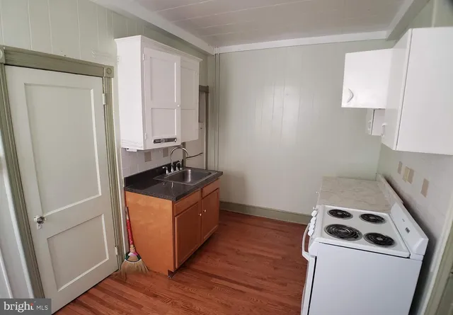 a kitchen with wooden cabinets and a stove top oven