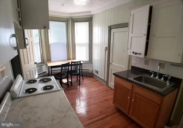 a kitchen with stainless steel appliances a stove a sink and a refrigerator