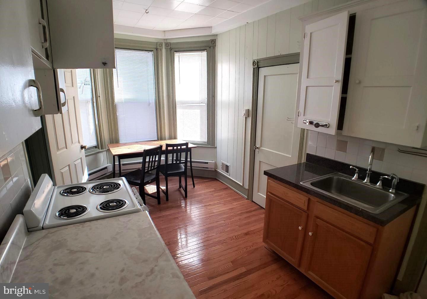 408 South 45th Street, Unit 2F Philadelphia, PA 19104 - Photo 5 of 6 a kitchen with stainless steel appliances a stove a sink and a refrigerator