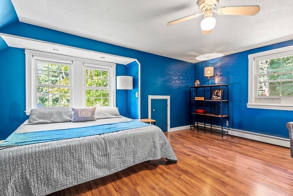 100 Circle Drive Wrentham, MA 02093 - Photo 25 of 42 a bedroom with a bed and a chandelier