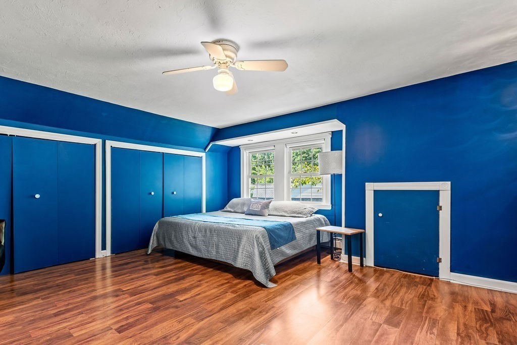 100 Circle Drive Wrentham, MA 02093 - Photo 26 of 42 a bedroom with a bed and a chandelier