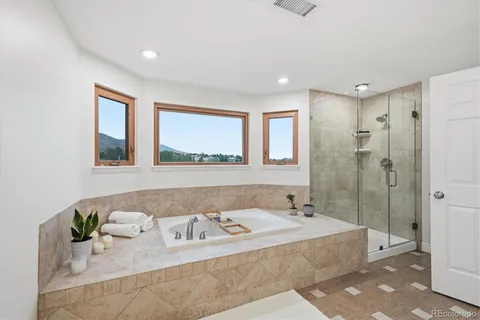 a bathroom with a tub sink and mirror