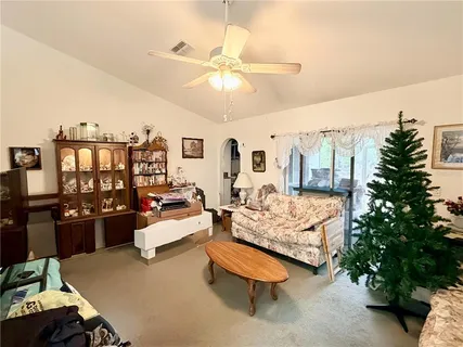 a living room with furniture and a chandelier