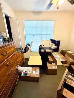 a bedroom with furniture and a mirror
