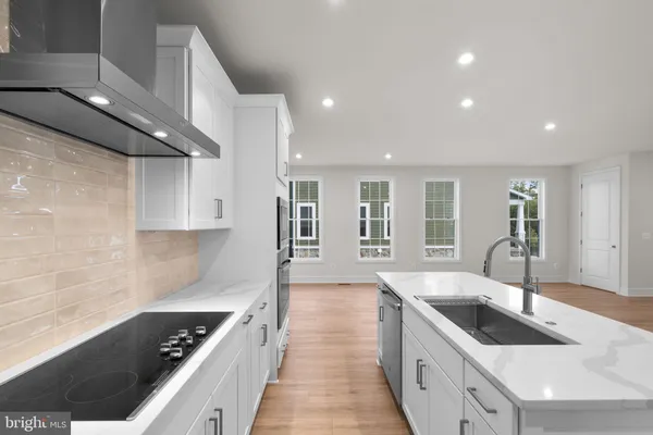 a kitchen with granite countertop a sink and stove