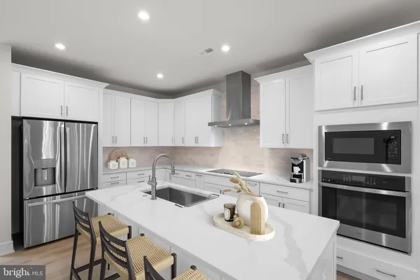 a kitchen with kitchen island a sink stove and refrigerator