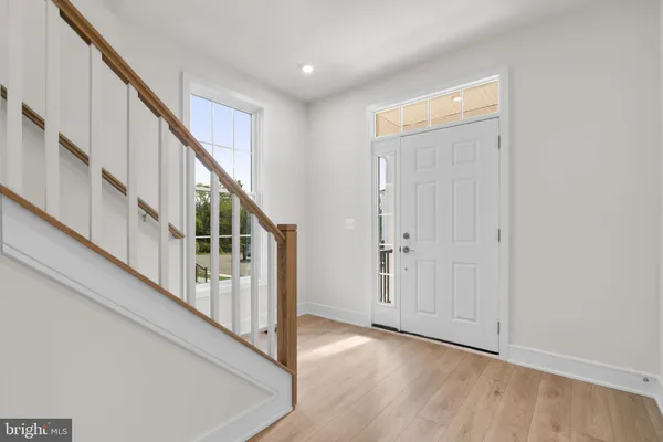 a view of an entryway with wooden floor