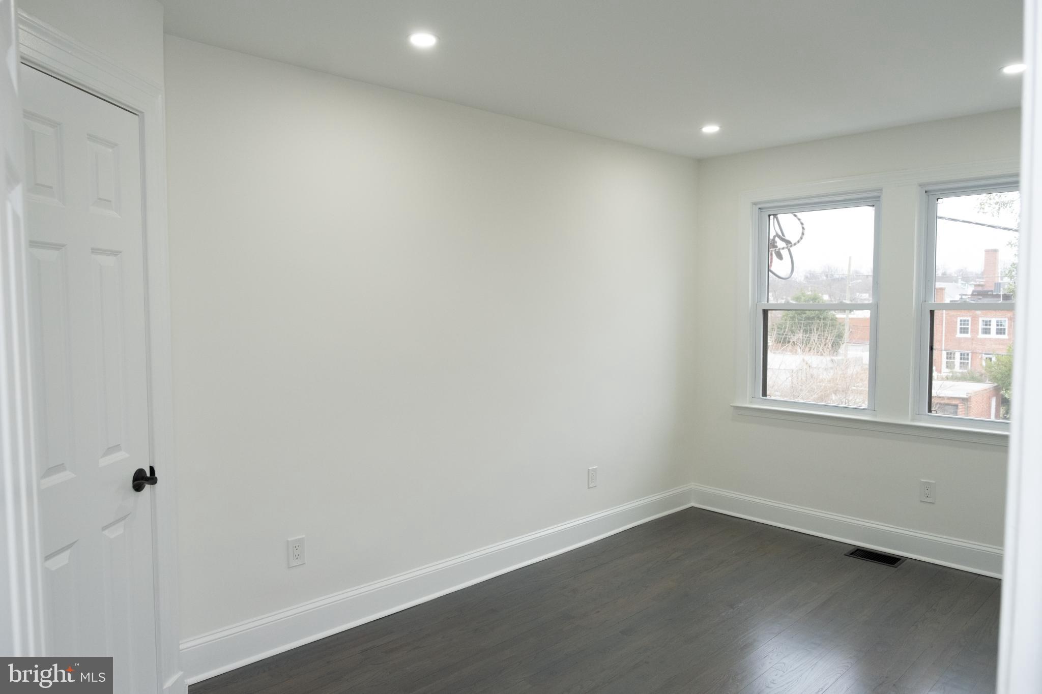 216 Jefferson Street Northwest, Unit A Washington, DC 20011 - Photo 13 of 32 wooden floor in an empty room with a window
