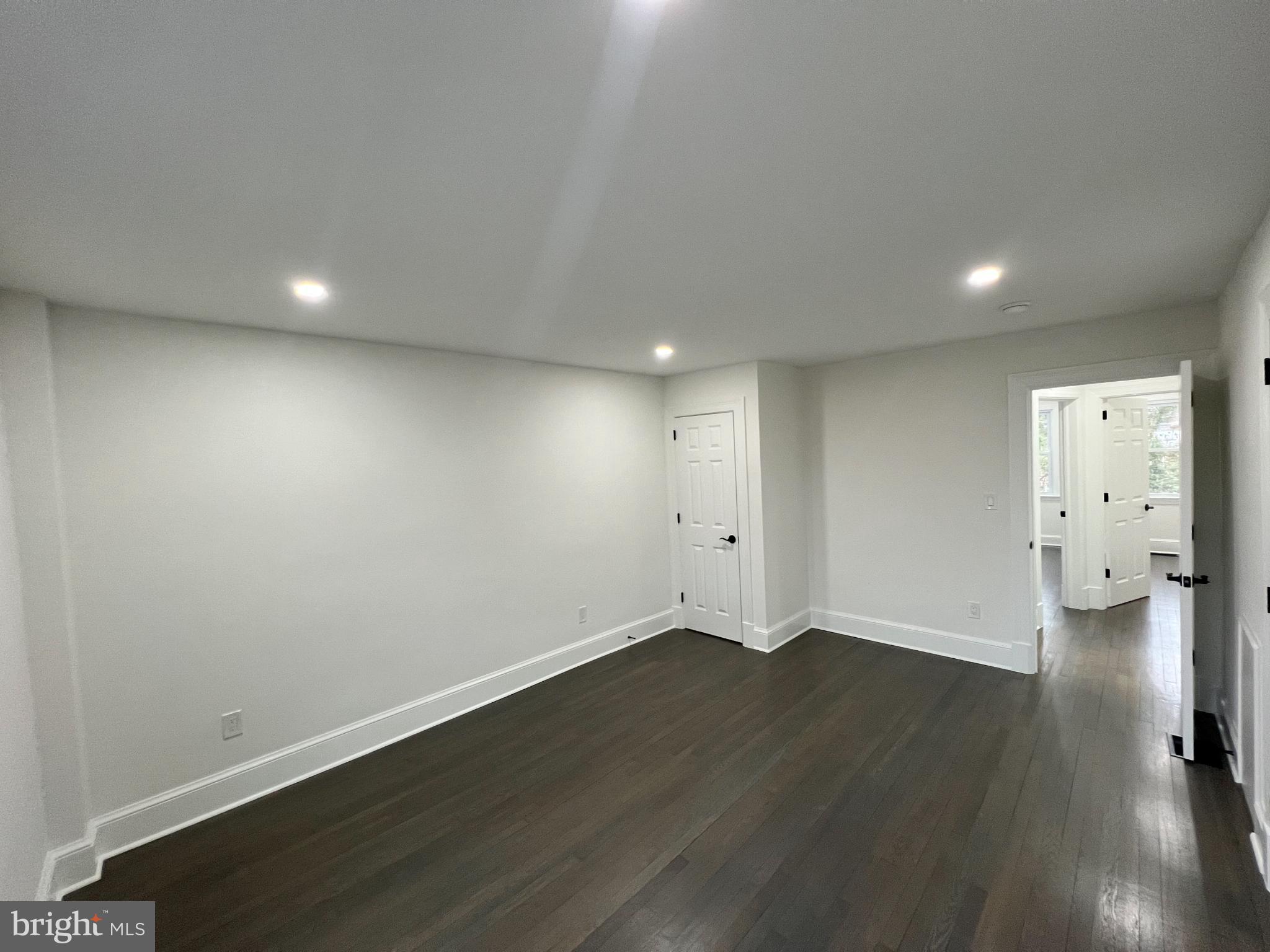 216 Jefferson Street Northwest, Unit A Washington, DC 20011 - Photo 15 of 32 an empty room with wooden floor and windows