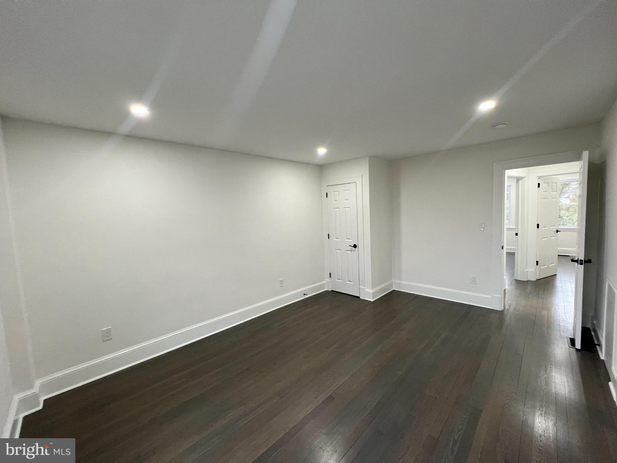 216 Jefferson Street Northwest, Unit A Washington, DC 20011 - Photo 16 of 32 an empty room with wooden floor and windows