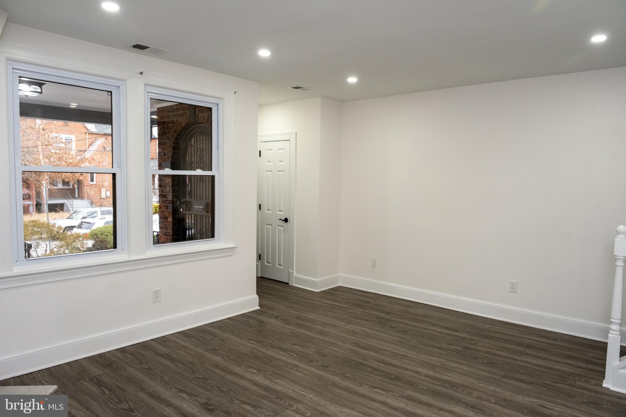 216 Jefferson Street Northwest, Unit A Washington, DC 20011 - Photo 18 of 32 an empty room with wooden floor and windows