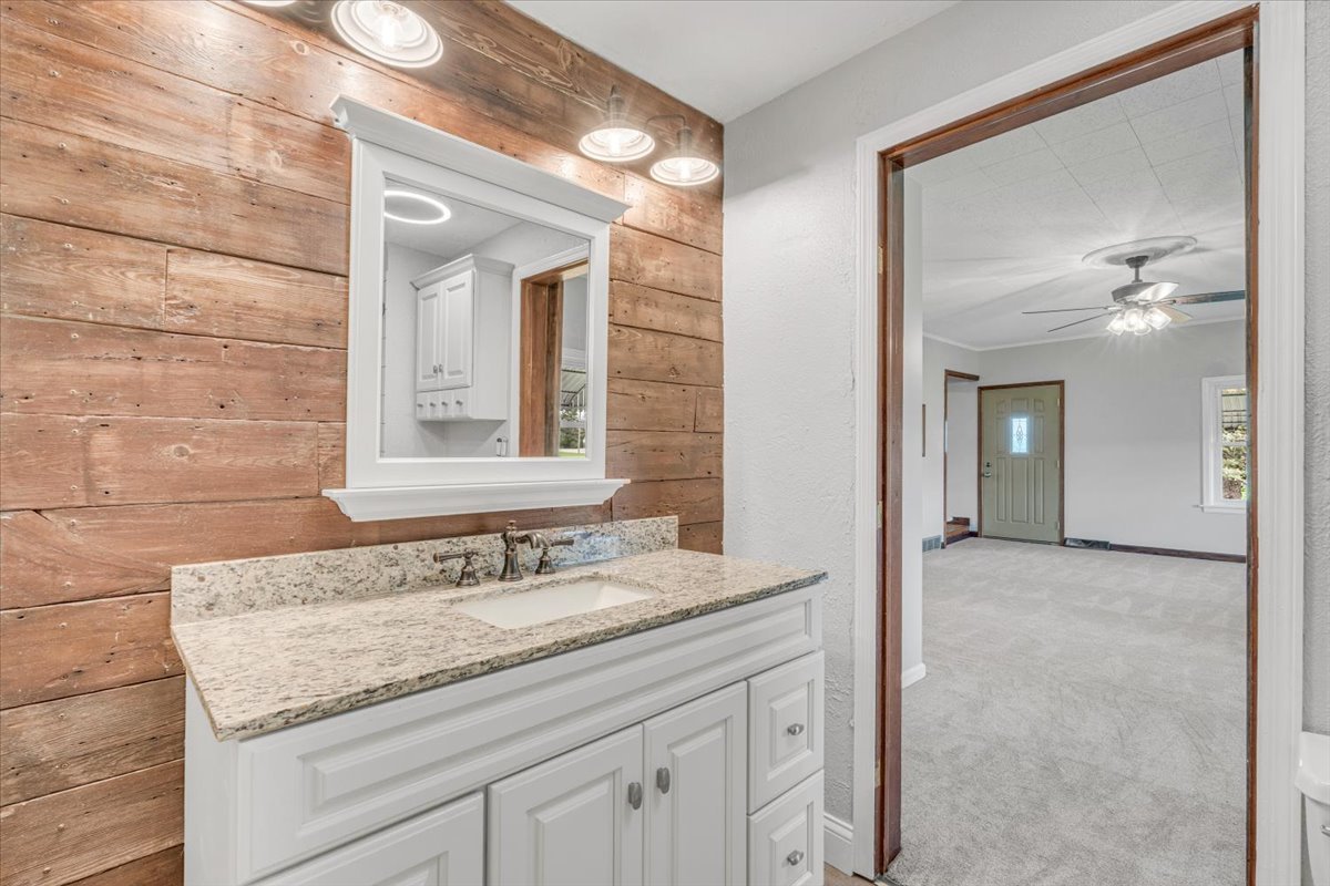 8850 Ridgewood Road Rock Island, IL 61201 - Photo 17 of 45 a bathroom with a granite countertop sink a mirror and a