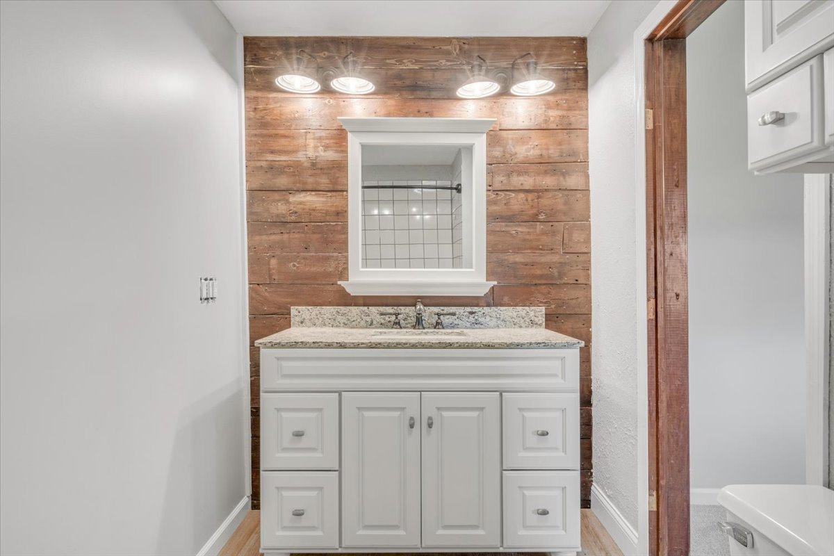 8850 Ridgewood Road Rock Island, IL 61201 - Photo 18 of 45 a bathroom with a granite countertop sink and a vanity