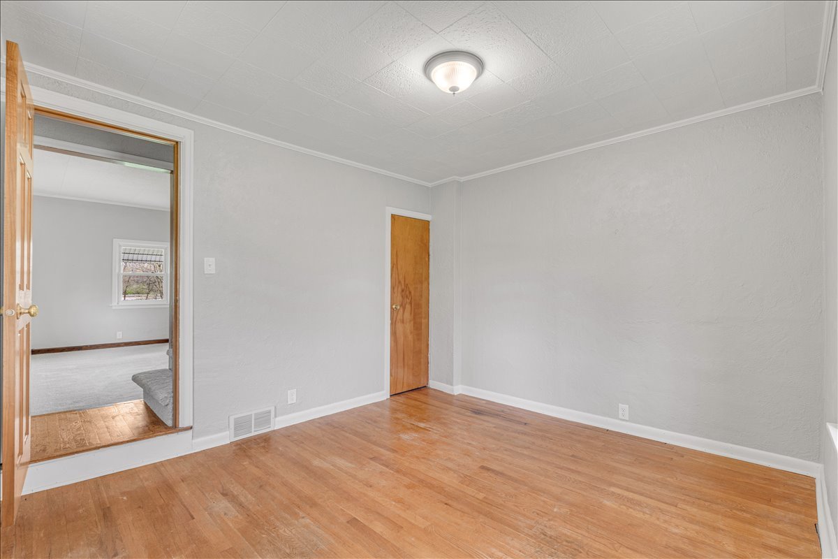 8850 Ridgewood Road Rock Island, IL 61201 - Photo 20 of 45 an empty room with wooden floor and windows