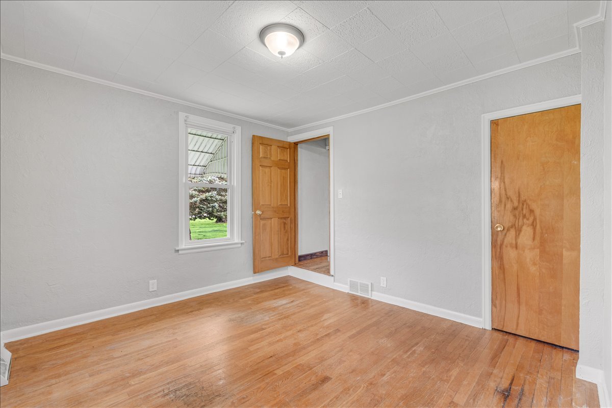 8850 Ridgewood Road Rock Island, IL 61201 - Photo 21 of 45 an empty room with wooden floor and windows