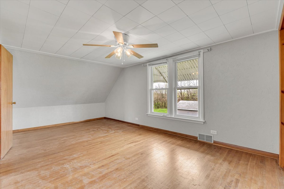 8850 Ridgewood Road Rock Island, IL 61201 - Photo 28 of 45 an empty room with wooden floor and windows