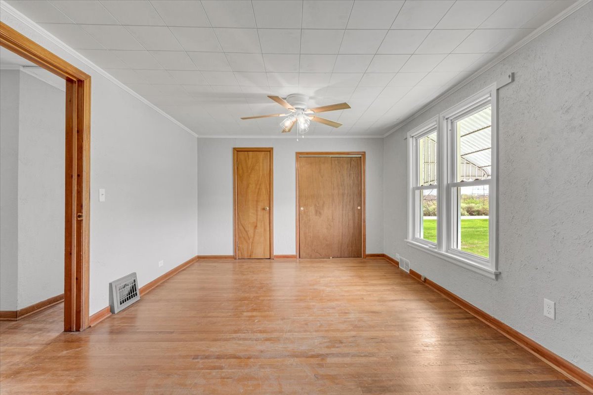 8850 Ridgewood Road Rock Island, IL 61201 - Photo 30 of 45 an empty room with windows and chandelier fan